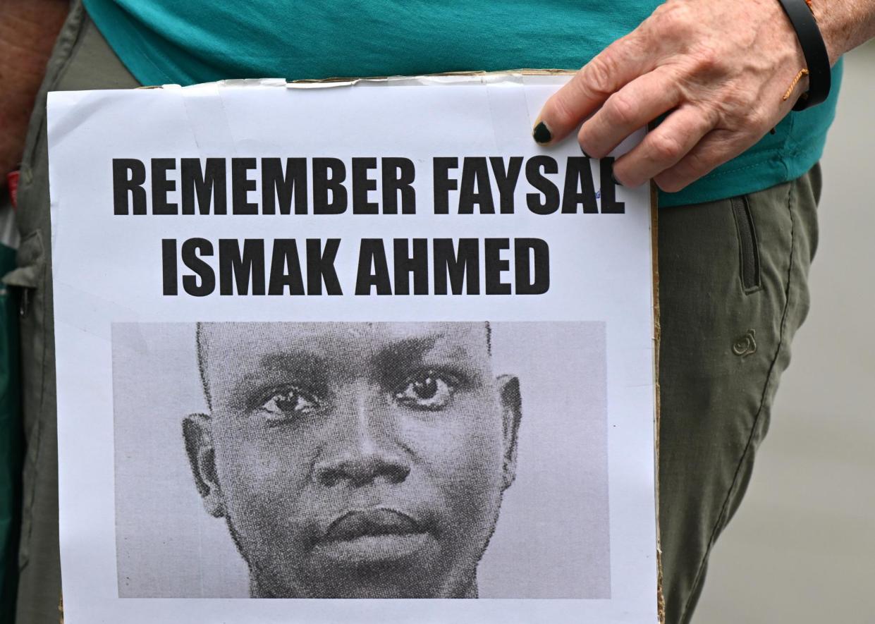 <span>A photo of Faysal Ishak Ahmed seen on a poster at a vigil in Brisbane at the inquest into his death after collapsing at the Manus Island detention centre.</span><span>Photograph: Darren England/AAP</span>