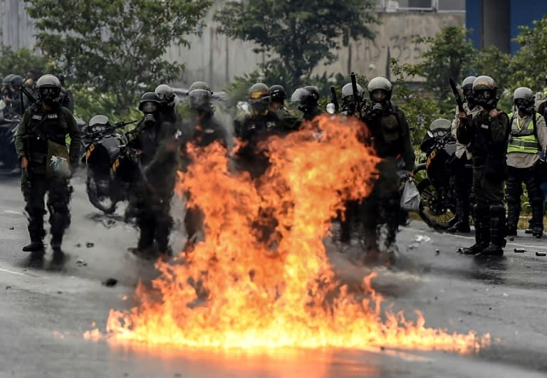 The Venezuelan National Guard stands guard as they clash with opposition activists clash in Caracas on April 13, 2017