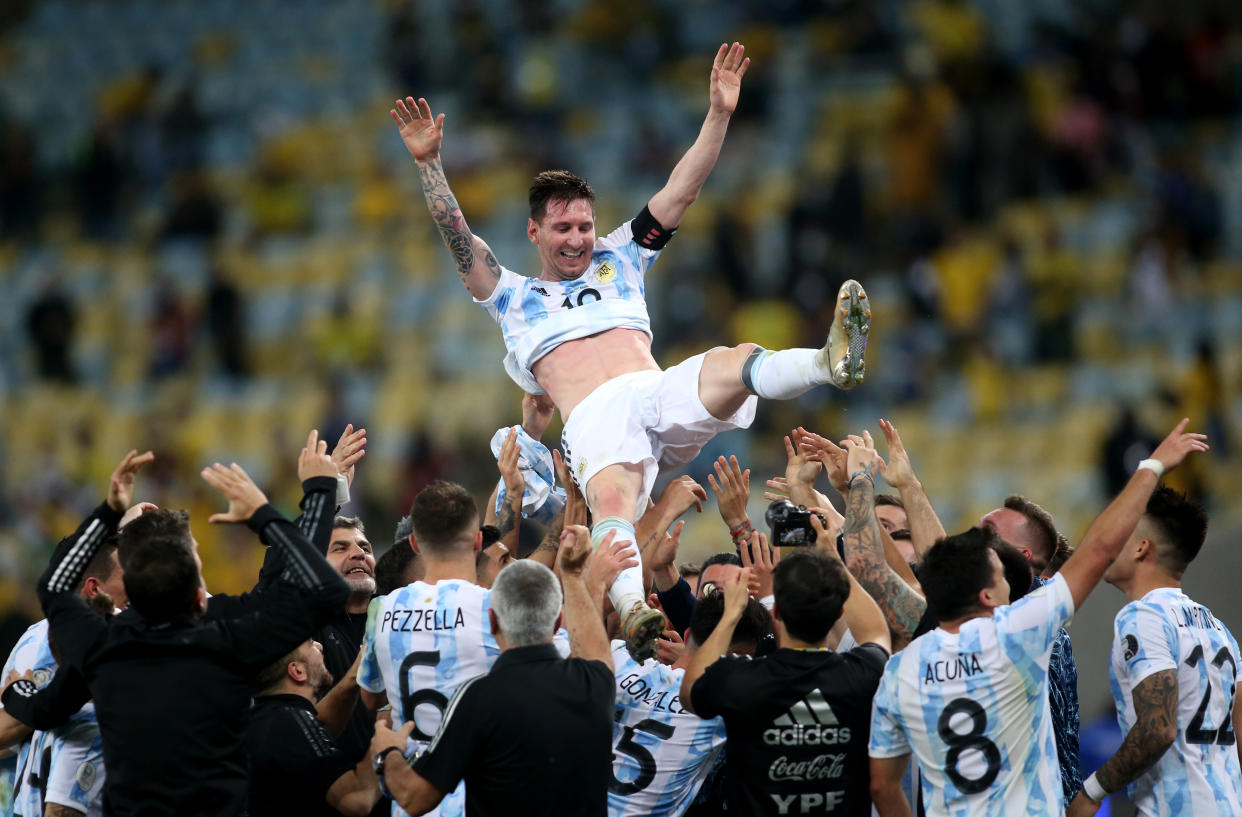 RIO DE JANEIRO, BRAZIL - JULY 10: Players of Argentina lift in the air their Captain Lionel Messi after winning the Final of Copa America Brazil 2021 ,during the Final Match between Brazil and Argentina at Maracana Stadium on July 10, 2021 in Rio de Janeiro, Brazil. (Photo by MB Media/Getty Images)