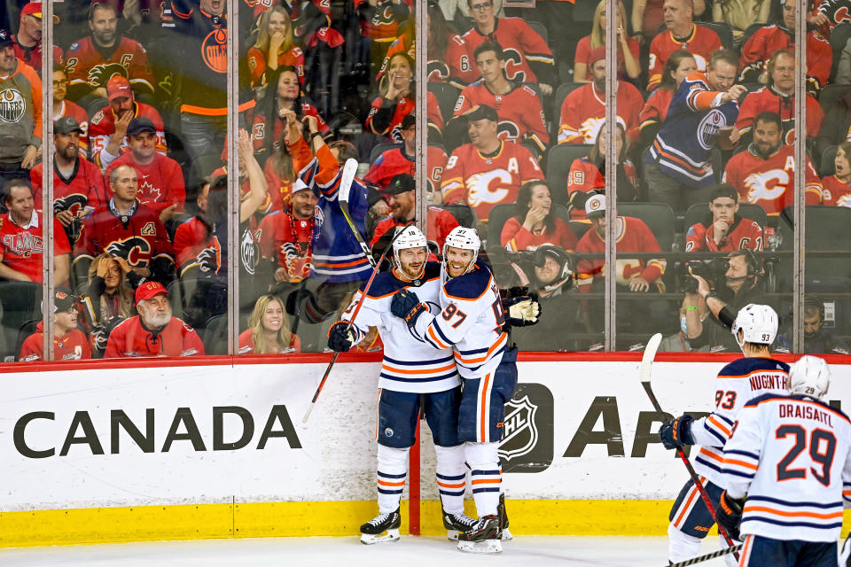 CALGARY, AB - MAY 26: Edmonton Oilers Right Wing Zach Hyman (18) celebrates a goal with Edmonton Oilers Center Connor McDavid (97) during the second period of game 5 of the second round of the NHL Stanley Cup Playoffs between the Calgary Flames and the Edmonton Oilers on May 26, 2022, at the Scotiabank Saddledome in Calgary, AB. (Photo by Brett Holmes/Icon Sportswire via Getty Images)