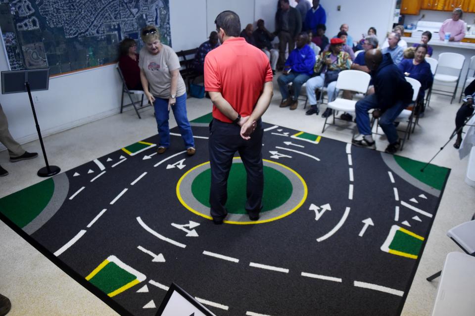 Eula Helpling, Of Wabasso, walks along a a floor model of the proposed roundabout for the intersection of 66th Avenue and County Road 510 at a community meeting Monday, Feb. 5, 2018 as Carlos Rodriguez, a transportation planning manager with Metric Engineering, looks on. "My main concern with the roundabout is the elderly adjusting to it," Helping said. "I don't think they will understand the difference between a roundabout and a traffic light. They don't adapt well to change and I don't think they should be expected to."