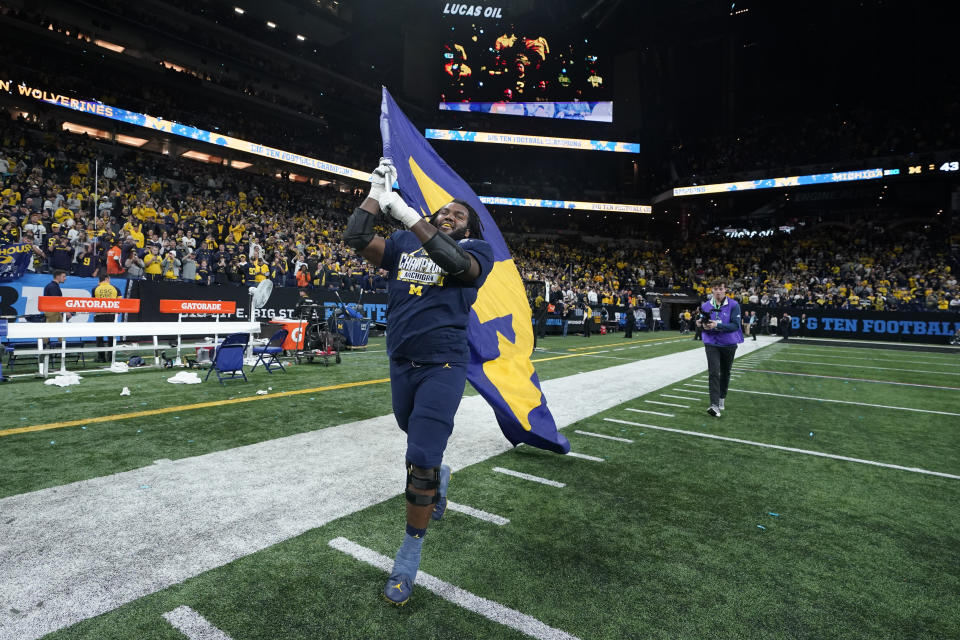 Michigan offensive lineman Trente Jones celebrates after defeating Purdue in the Big Ten championship NCAA college football game, early Sunday, Dec. 4, 2022, in Indianapolis. Michigan won, 43-22. (AP Photo/Darron Cummings)