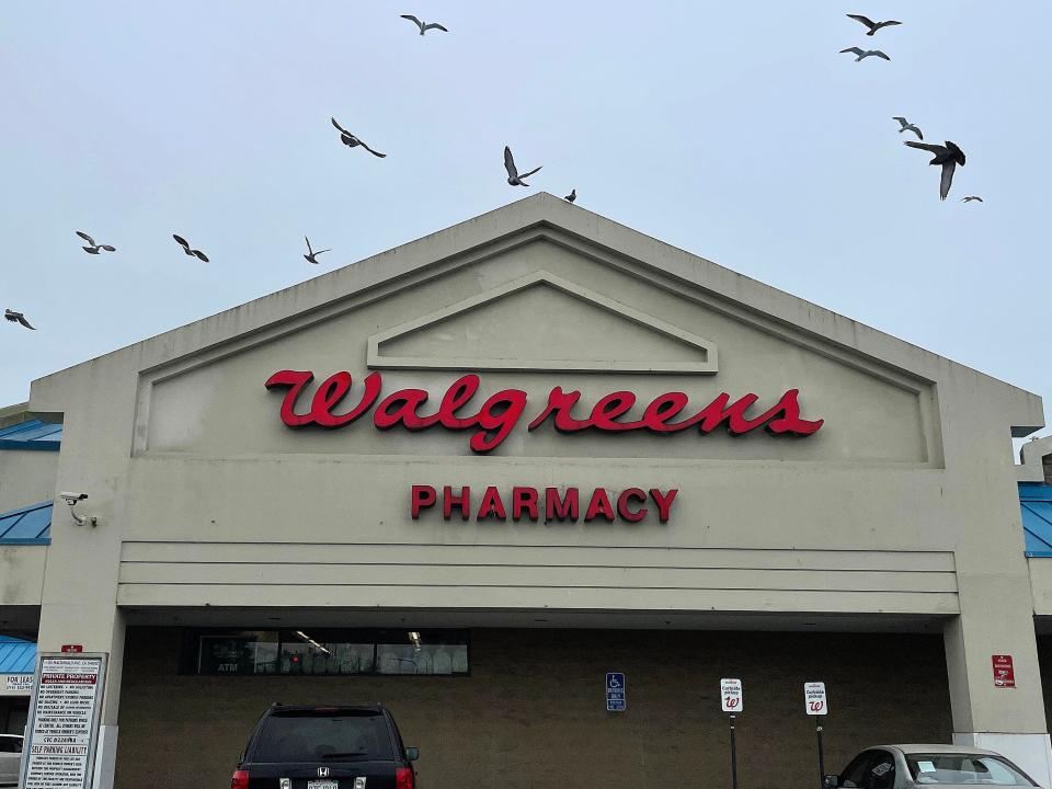 Birds fly by a sign posted on the exterior of a Walgreens store on March 09, 2023 in Richmond, California.