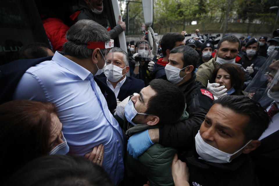 Demonstrators, some wearing face masks for protection against coronavirus, are pushed into a police vehicle after they were arrested by Turkish police officers during May Day protests in Istanbul, Friday, May 1, 2020. Police in Istanbul detained several demonstrators who tried to march toward Istanbul’s symbolic Taksim Square in defiance of the lockdown imposed by the government due to the coronavirus outbreak. (AP Photo/Emrah Gurel)