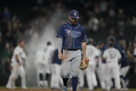 Tampa Bay Rays second baseman Brandon Lowe walks off the field as the Seattle Mariners celebrate after Kyle Seager drove in the winning run with a single in the ninth inning of a baseball game Thursday, June 17, 2021, in Seattle. The Mariners won 6-5. (AP Photo/Ted S. Warren)