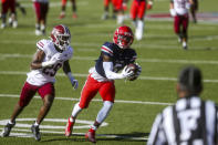 Liberty wide receiver DJ Stubbs (5) hauls in a pass as he is defended by Massachusetts player Cody Jones (29) during the first half of an NCAA college football game on Friday, Nov. 27, 2020, at Williams Stadium in Lynchburg, Va. (AP Photo/Shaban Athuman)