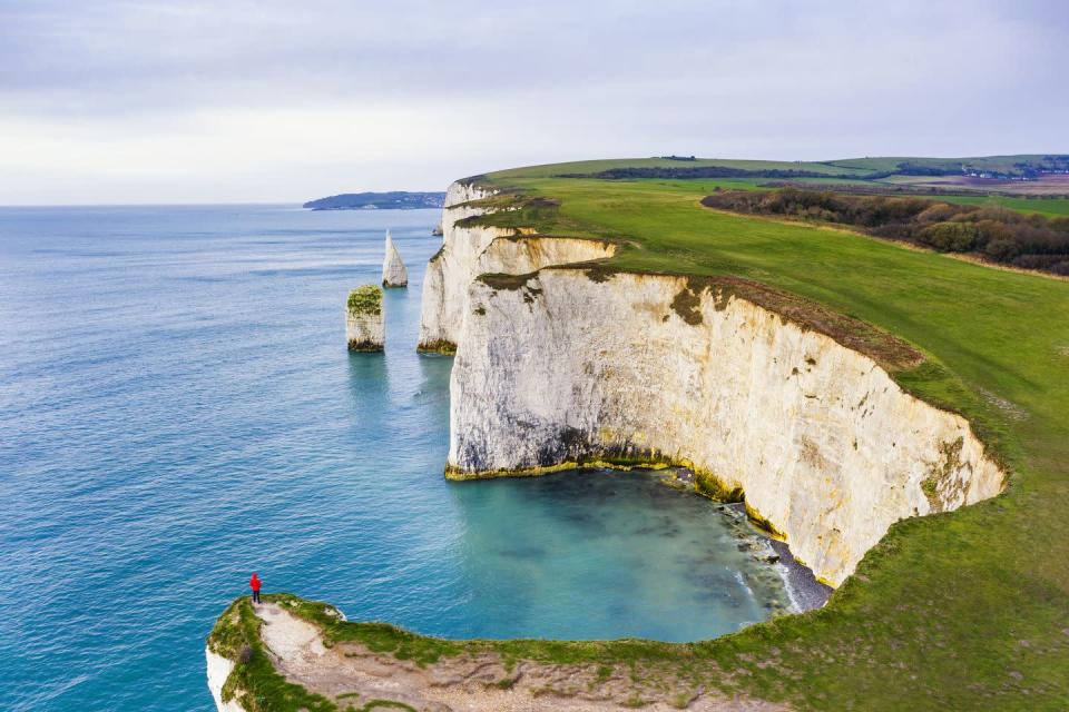<p>No roundup of the best coastal walks in the UK could be complete with mentioning Old Harry Rocks, the infamous white chalk stacks thought to be named after a local notorious pirate, Harry Paye. </p><p>This cliff-top walk is one of the best ways to take in the Jurassic Coast and those who visit in spring and summer can expect to see distinctive, and rare, pink pyramidal orchids.</p><p><strong>Where to stay:</strong> Stunning sea views are on offer at the cliff-top <a href="https://www.booking.com/hotel/gb/the-pines-swanage.en-gb.html?aid=2070935&label=coastal-walks" rel="nofollow noopener" target="_blank" data-ylk="slk:Pines Hotel" class="link rapid-noclick-resp">Pines Hotel</a> overlooking Swanage Bay, at the end of the 95-mile stretch of Jurassic Coast. With private steps down to the beach, The Pines will set you up with a hearty breakfast and easy access to begin your walk.</p><p><a class="link rapid-noclick-resp" href="https://www.booking.com/hotel/gb/the-pines-swanage.en-gb.html?aid=2070935&label=coastal-walks" rel="nofollow noopener" target="_blank" data-ylk="slk:CHECK AVAILABILITY">CHECK AVAILABILITY</a></p>