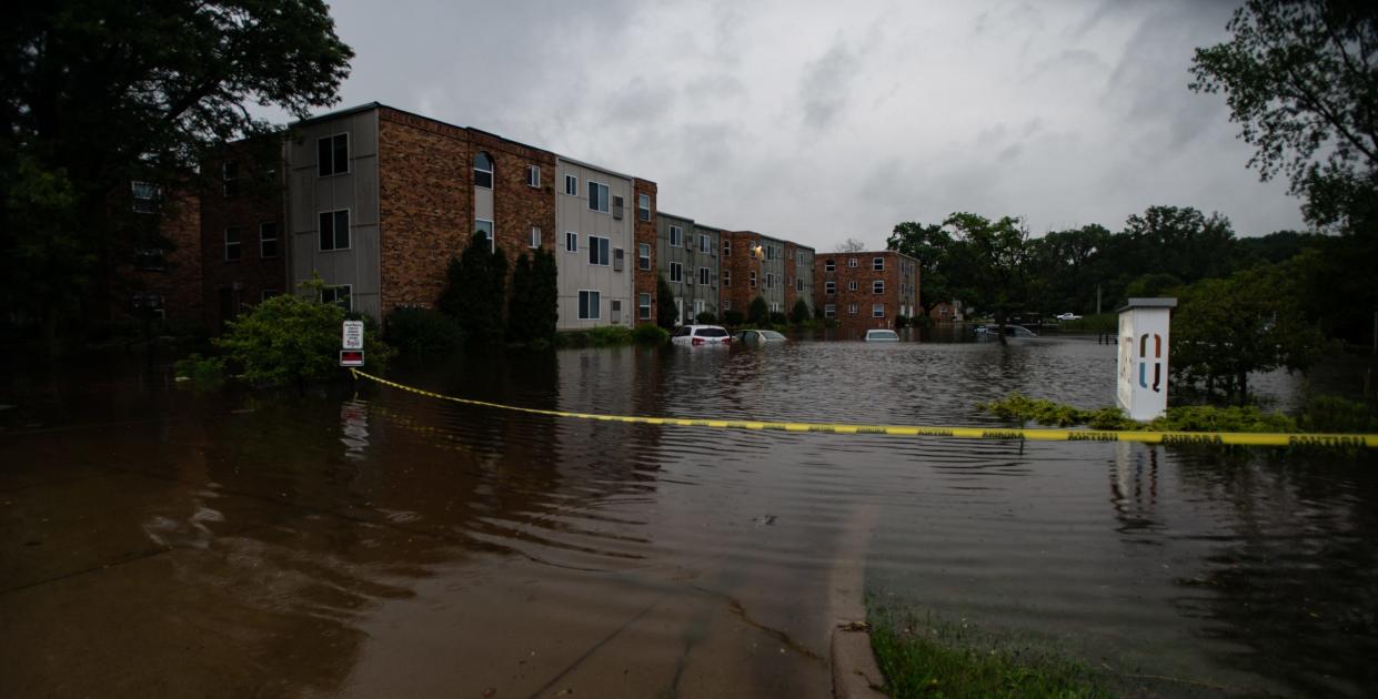 Submerged vehicles seen at The Quarters of East Lansing apartment complex on Abbot Road, Wednesday, July 10, 2024.