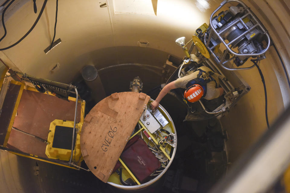 FILE - In this image provided by the U.S. Air Force, Airman 1st Class Jackson Ligon, 341st Missile Maintenance Squadron technician, examines the internals of an intercontinental ballistic missile during a Simulated Electronic Launch-Minuteman test Sept. 22, 2020, at a launch facility near Malmstrom Air Force Base in Great Falls, Mont. The Air Force says a review of a Montana nuclear missile base where an unusual number of troops have reported being diagnosed with non-Hodgkin's lymphoma has found no immediate risk factors. The same was true at two other bases that could launch ground-based warheads, the service said in a report obtained by the Associated Press. (Tristan Day/U.S. Air Force via AP)