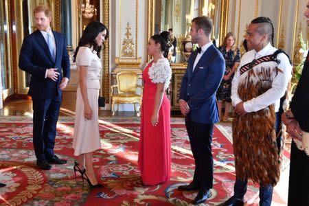 Britain's Prince Harry and Meghan, the Duchess of Sussex meet group of Queen's Young Leaders at a Buckingham Palace reception following the final Queen's Young Leaders Awards Ceremony, in London, June 26, 2018. John Stillwell/Pool via Reuters