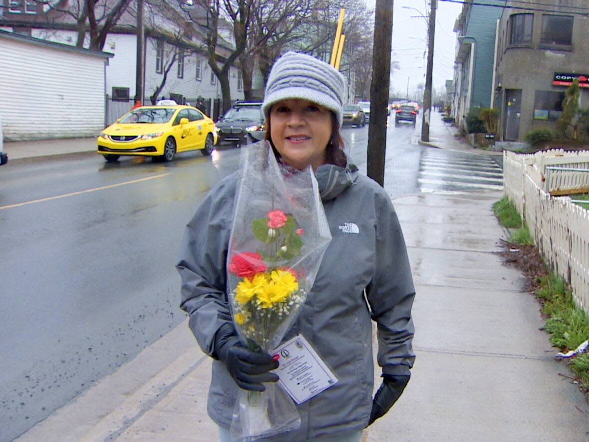 Corie Outerbridge, coordinator of the annual Lonely Bouquet Campaign, hit the streets of St. John's Friday morning to deliver flowers.  (Mike Simms/CBC - image credit)