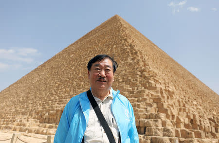 Japanese archaeologist Sakuji Yoshimura stands in front of the Great Pyramids where the second Khufu boat discovery was made in Giza, Egypt March 29, 2017. REUTERS/Mohamed Abd El Ghany