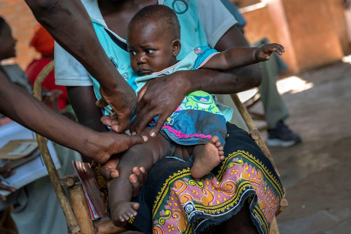 A baby is given another malaria vaccine in Malawi in 2019 (AP)