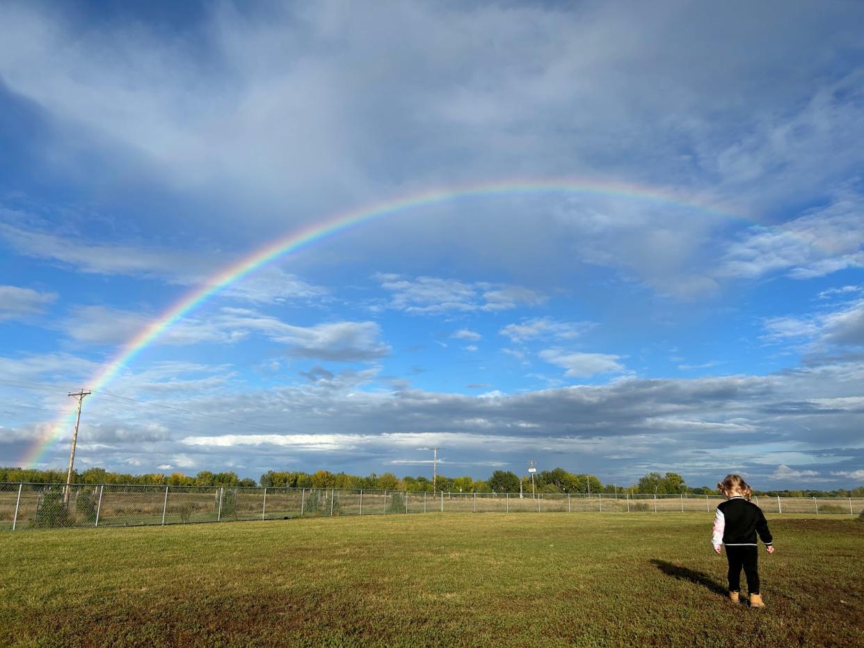 Girl outside with rainbow