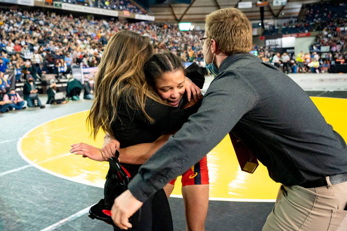 Mount Tahoma’s Zeta Lee celebrates with her coaches after beating Toppenish’s Mia Zuniga 110-pound girls championship match at Mat Classic XXXIII on Saturday, Feb. 19, 2022, at the Tacoma Dome in Tacoma, Wash. Lee won by major decision, 9-0.