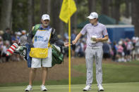 Matt Fitzpatrick, right, of England, hands his ball off to his caddie on the first green during the first round of the RBC Heritage golf tournament, Thursday, April 13, 2023, in Hilton Head Island, S.C. (AP Photo/Stephen B. Morton)