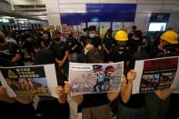 Protest at Yuen Long MTR station, the scene of an attack by suspected triad gang members a month ago