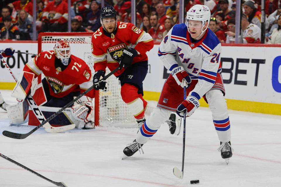 May 26, 2024; Sunrise, Florida, USA; New York Rangers right wing Kaapo Kakko (24) moves the puck against the Florida Panthers during the second period in game three of the Eastern Conference Final of the 2024 Stanley Cup Playoffs at Amerant Bank Arena.