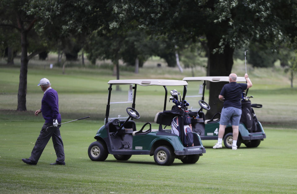 Golfers play on the golf course which would usually be used as a car park for Wimbledon tennis tournament visitors, in Wimbledon in London, Monday, June 29, 2020. The 2020 Wimbledon Tennis Championships, due to start Monday were cancelled due to the Coronavirus pandemic. (AP Photo/Kirsty Wigglesworth)