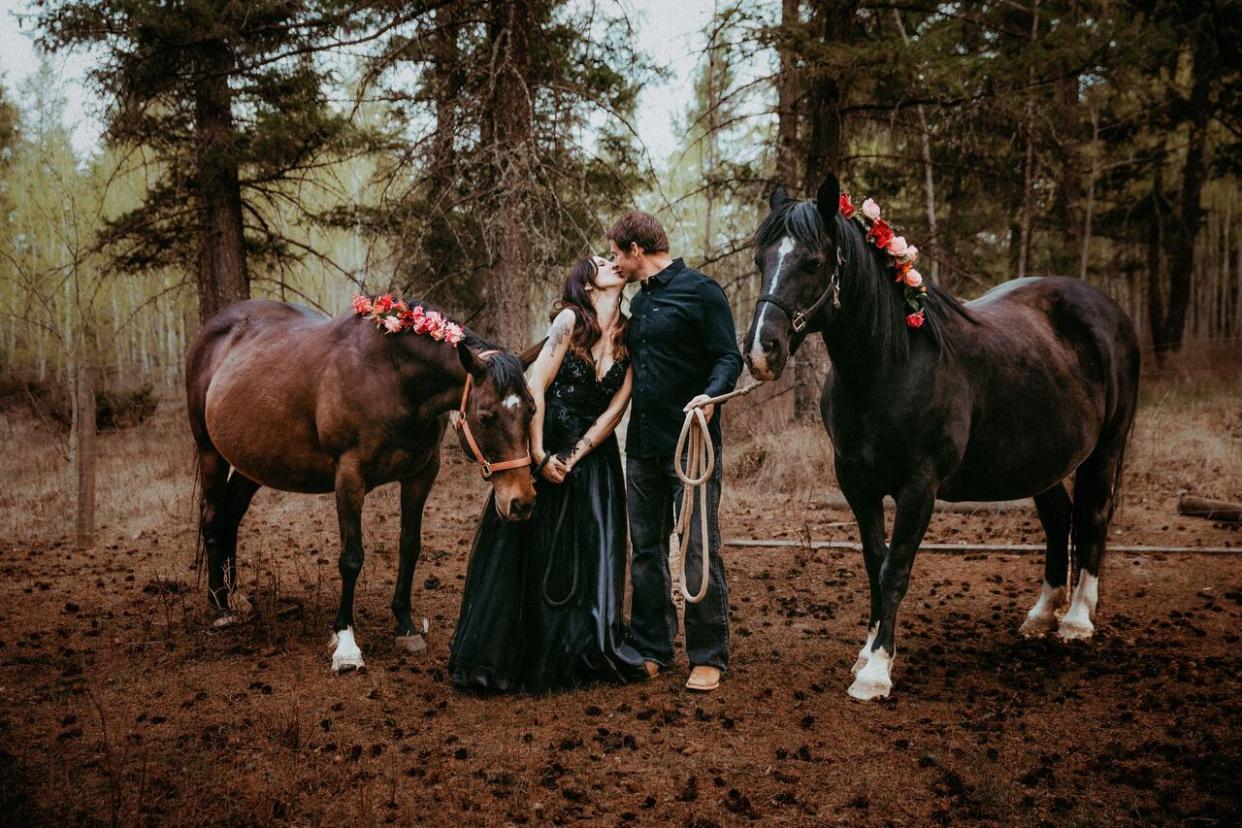 Tiffany Jorgensen and her husband pose with their pregnant horses Rosie and Tessa. (Submitted by Laureen Carruthers - image credit)
