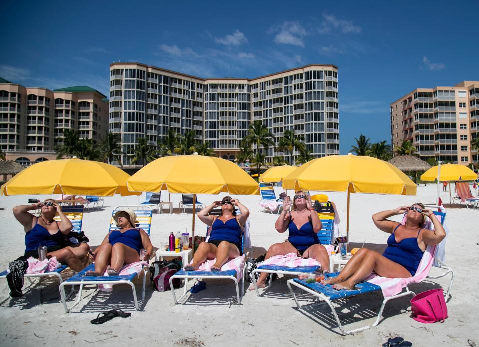 A group of friends from northern Kentucky gathered at the Pink Shell Resort at Fort Myers Beach to see the solar eclipse on Monday, August 21, 2017.