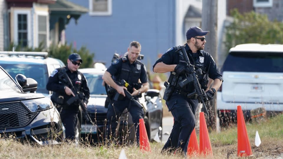Members of law enforcement arrived Friday at a farm in Lisbon Falls, Maine, as they searched for a suspect in Wednesday's deadly shooting in Lewiston. - Kevin Lamarque/Reuters