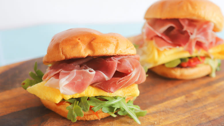 Prosciutto breakfast sandwiches on wood