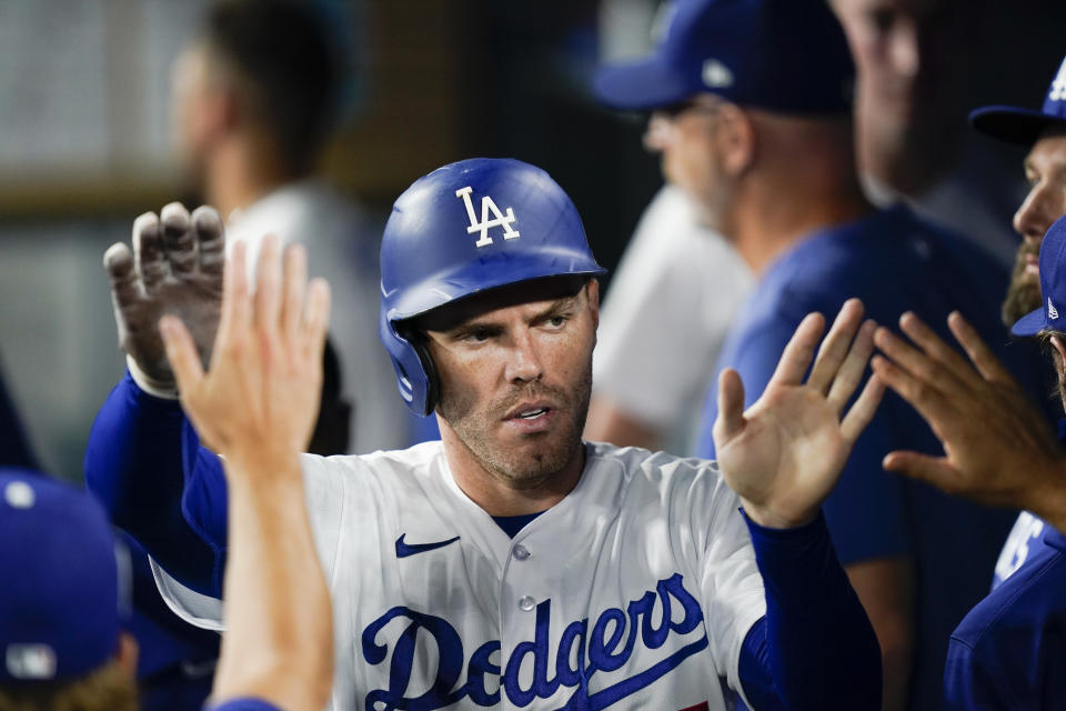 Los Angeles Dodgers' Freddie Freeman celebrates in the dugout after scoring on a single hit by designated hitter J.D Martinez during the ninth inning of a baseball game against the San Diego Padres, Monday, Sept. 11, 2023, in Los Angeles. (AP Photo/Ryan Sun)