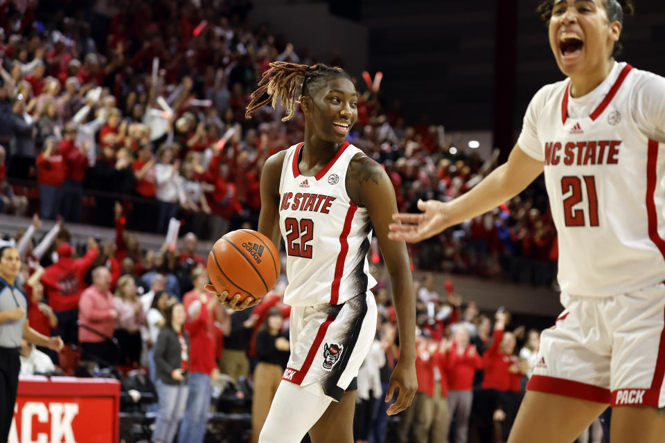 North Carolina State's Saniya Rivers (22) celebrates with teammate Madison Hayes (21) during the final minutes of an NCAA college basketball game against UConn, Sunday, Nov. 12, 2023, in Raleigh, N.C. (AP Photo/Karl B. DeBlaker)