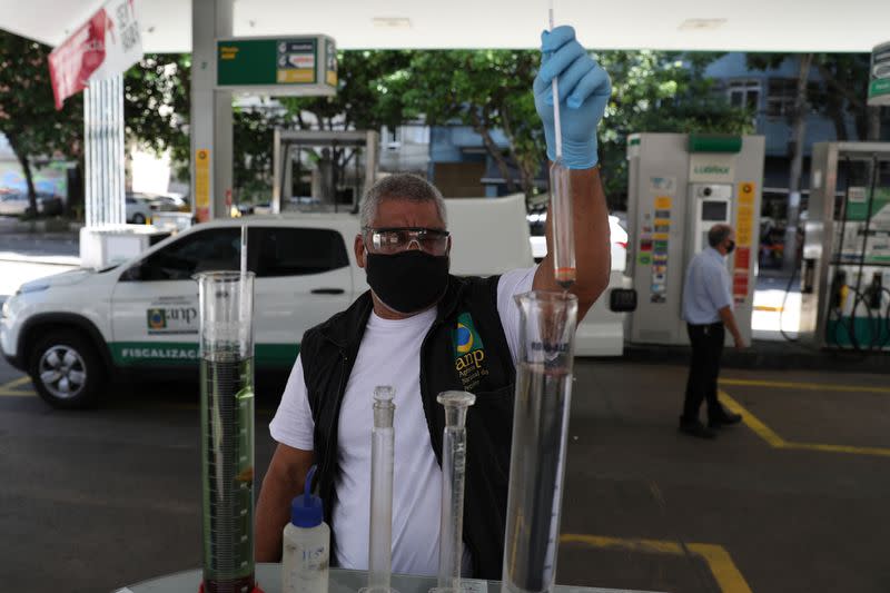 A worker of National Petroleum Agency ANP, makes a procedure to check fuel quality at a gas station in Rio de Janeiro