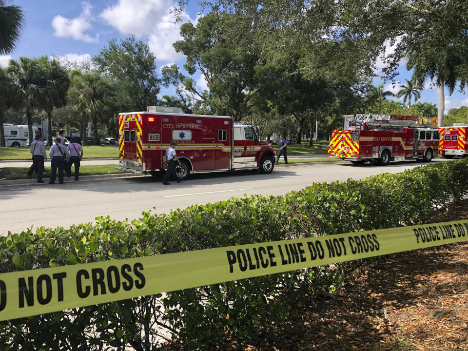 Officials from various departments work the scene outside the office of U.S. Rep. Deborah Wasserman Schultz, where a suspicious package was discovered Wednesday, Oct. 24, 2018, in Sunrise, Fla. (Taimy Alvarez/South Florida Sun-Sentinel via AP)