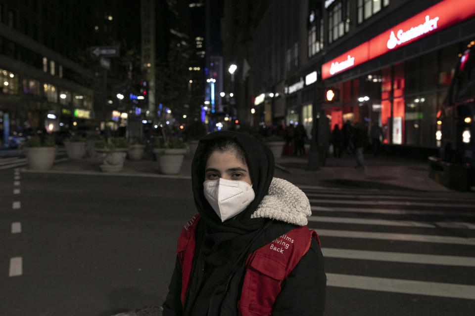 Dania Darwish, 27, director of the Asiyah Women's Center and a volunteer with Muslims Giving Back rests after handing out food to the hungry in Herald Square, New York, on Tuesday, April 28, 2020. For Darwish and a group of Brooklyn Muslims, the holy month of Ramadan is a blur: They fast during daylight hours, pray repeatedly, and use every bit of their remaining energy to feed the hungry. (AP Photo/Wong Maye-E)