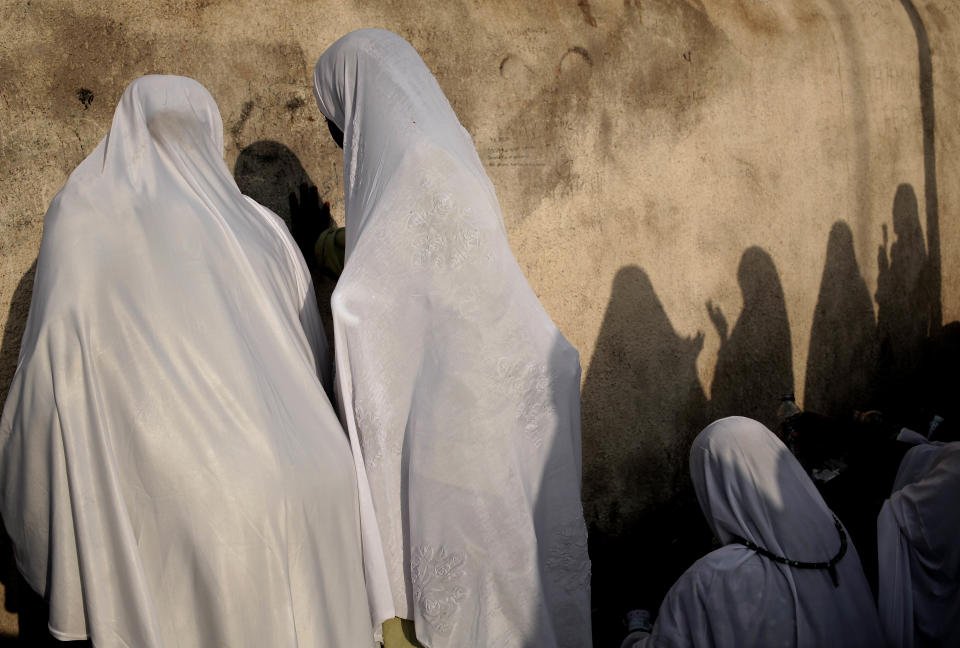 FILE - In this Sept. 11, 2016 file photo, Sudanese women pray on a rocky hill known as Jabal al-Rahma, or Mountain of Mercy, on the Plain of Arafat, on the second day of the annual hajj pilgrimage, near the holy city of Mecca, Saudi Arabia. It is here where the Prophet Muhammad delivered his final sermon, calling for equality among mankind and for Muslim unity. He reminded his followers of women's rights and that every Muslim life and property is sacred. (AP Photo/Nariman El-Mofty, File)