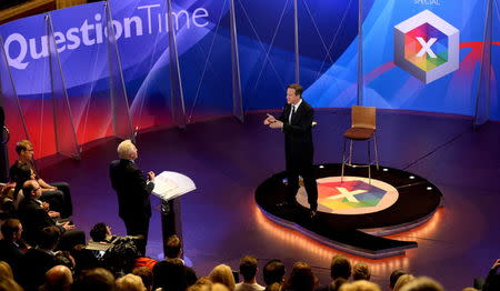 Prime Minister David Cameron takes part in a special BBC Question Time programme, hosted by David Dimbleby (standing left), with the three main party leaders appearing separately at Leeds Town Hall, West Yorkshire, during the General Election 2015 campaign. Thursday April 30, 2015. REUTERS/Stefan Rousseau/PA Wire/Pool