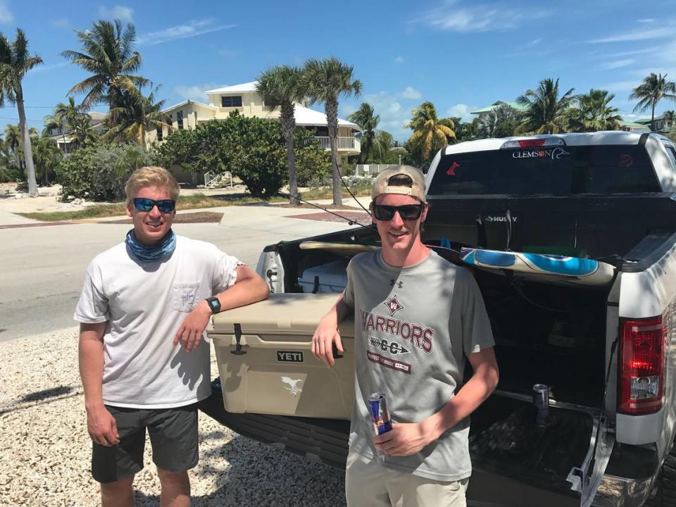 Race Jones and Andy Burlos, two Clemson University students, stand besinde their pickup truck in Marathon, Florida, Wednesday, March 18, 2020. They hit the road from South Carolina Sunday, March 15, 2020, to eventually make it to Key West in a pickup truck. They stopped to fish and surf along the way. Once they made it to the Keys though, their plans changed because camp grounds in the island chain are closed due to the COVID-19 pandemic.