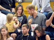 The dapper Prince was a hit with the little girl, who made funny faces back at the royal.