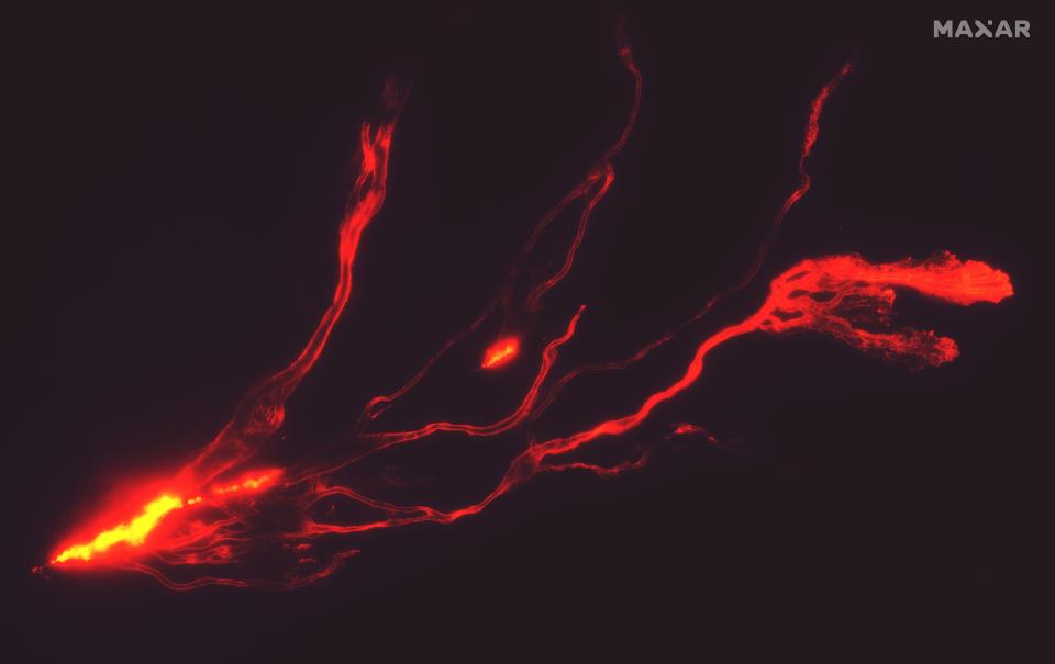 A handout satellite image made available by Maxar Technologies shows a night time overview of lava flows from Mauna Loa (EPA)