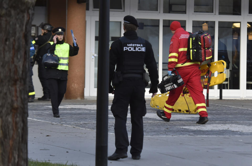 Police personnel and paramedics outside the Ostrava Teaching Hospital after a shooting incident in Ostava, Czech Republic, Tuesday, Dec. 10, 2019. Police and officials say at least four people have been killed in a shooting in a hospital in the eastern Czech Republic. Two others are seriously injured. (Jaroslav Ozana/CTK via AP)