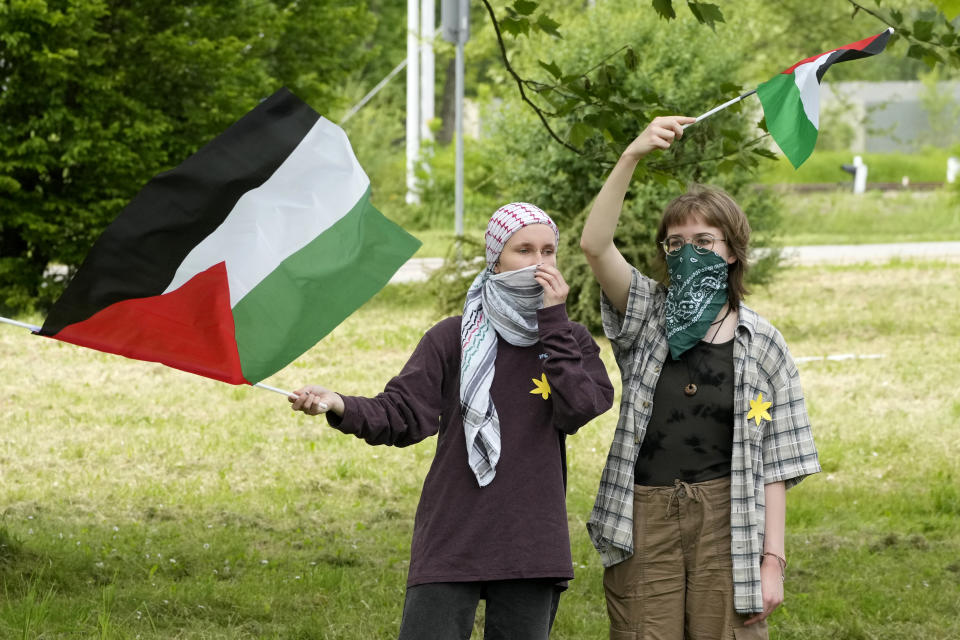 Protesters wave Palestinian flags as the annual Holocaust remembrance event, the "March of the Living" in memory of the six million Holocaust victims takes place in Oswiecim, Poland, Monday, May 6, 2024. The event comes amid the dramatic backdrop of the violence of the Israel-Hamas war after the Oct. 7 Hamas attack, the deadliest violence against Jews since the Holocaust, and as pro-Palestinian protests sweep U.S. campuses. (AP Photo/Czarek Sokolowski)