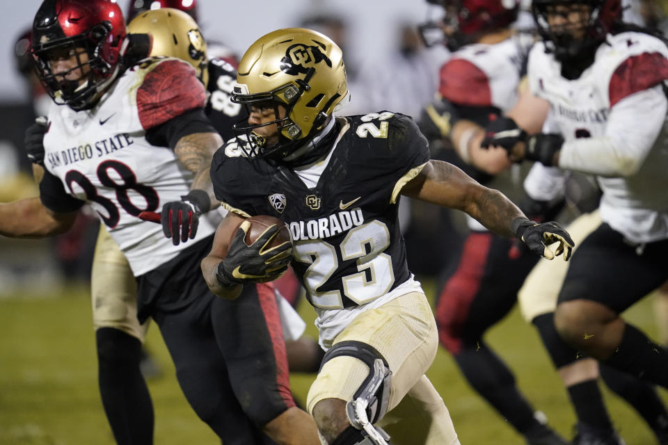 FILE - In this Nov. 28, 2020, file photo, Colorado running back Jarek Broussard, front, runs for a short gain as San Diego State linebacker Andrew Aleki pursues during the second half of an NCAA college football game in Boulder, Colo. Broussard was selected as the PAC-12 offensive player of the year along with Oregon State running back Jermar Jefferson. (AP Photo/David Zalubowski, File)