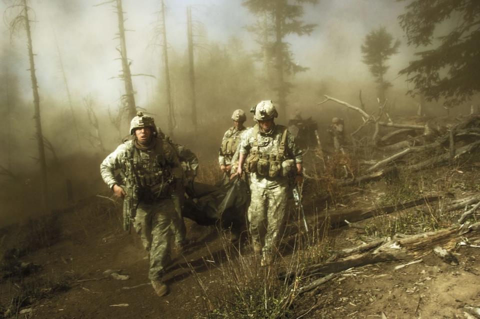 <div class="inline-image__caption"><p>US troops carry the body of Staff Sergeant Larry Rougle, who was killed when Taliban insurgents ambushed their squad in the Korengal Valley, Afghanistan, October 2007.</p></div> <div class="inline-image__credit">Lynsey Addario</div>