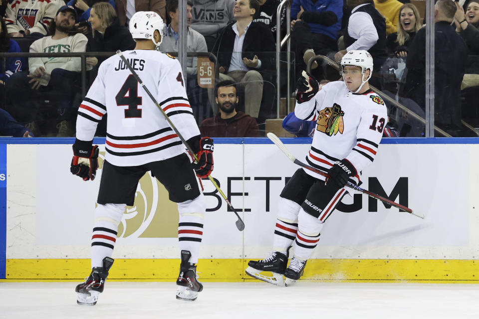 Chicago Blackhawks center Max Domi (13) celebrates with defenseman Seth Jones (4) after scoring a goal against the New York Rangers during the second period of an NHL hockey game, Saturday, Dec. 3, 2022, in New York. (AP Photo/Jessie Alcheh)