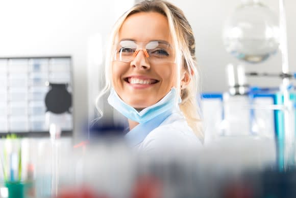 Smiling scientist in a lab.