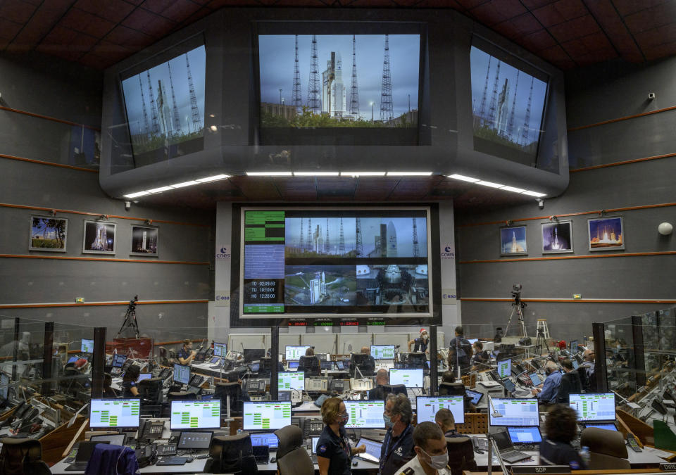 Launch teams monitor the countdown to the launch of Arianespace's Ariane 5 rocket carrying NASA's James Webb Space Telescope, Saturday, Dec. 25, 2021, in the Jupiter Center at the Guiana Space Center in Kourou, French Guiana. The world's largest and most powerful space telescope has blasted off on a high-stakes quest to behold light from the first stars and galaxies. NASA's James Webb Space Telescope rocketed away Saturday from French Guiana in South America. (NASA/Bill Ingalls/NASA via AP)