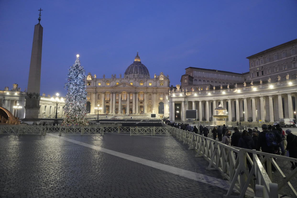 Faithful arrive at dawn to view the body of Pope Emeritus Benedict XVI as it lies in state in St. Peter's Basilica at the Vatican, Wednesday, Jan. 4, 2023. The Vatican announced that Pope Benedict died on Dec. 31, 2022, aged 95, and that his funeral will be held on Thursday, Jan. 5, 2023. (AP Photo/Gregorio Borgia)