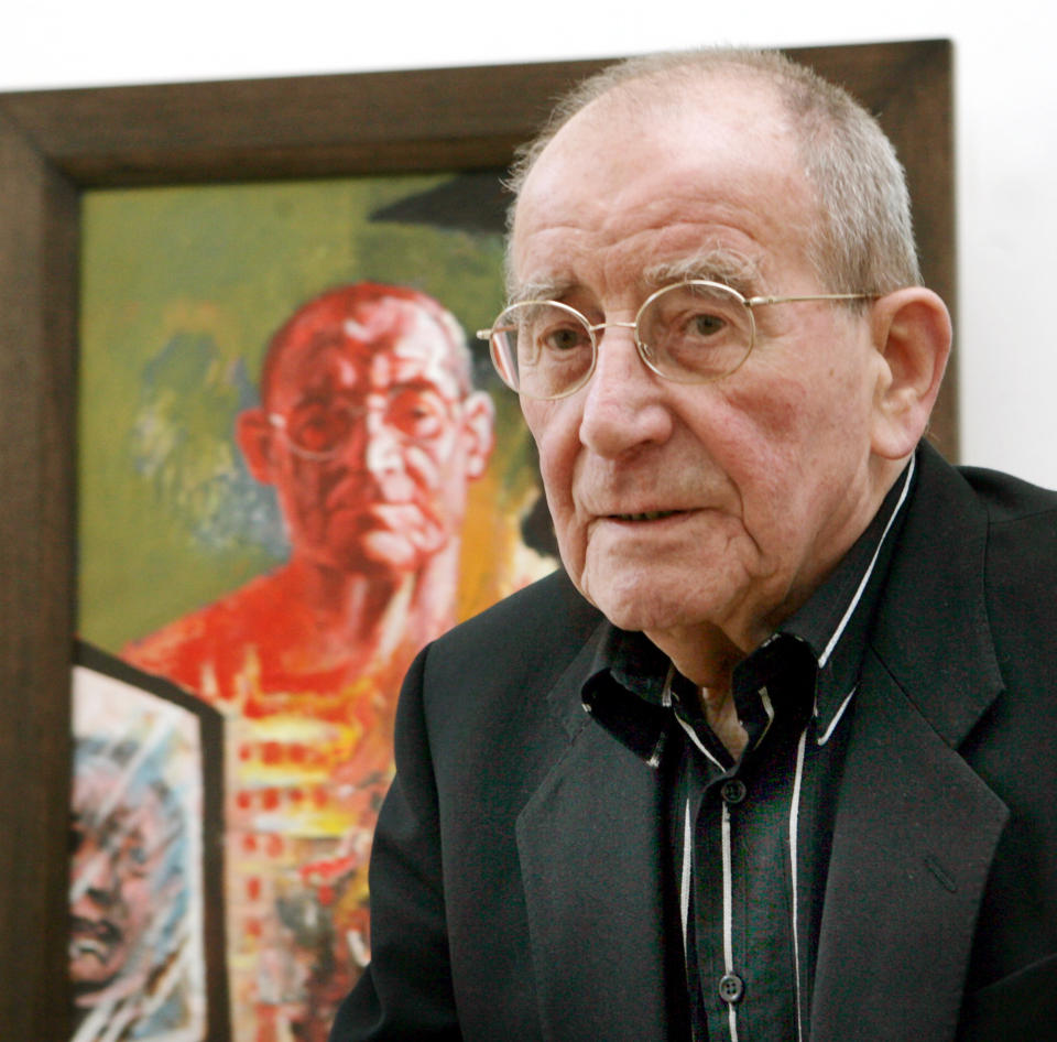 FILE - In this March 10, 2007 file picture German painter Willi Sitte waits in the gallery for contemporary Art in front of his self-portrait 'Me and Kosovo' (1999) in Merseburg, Germany. According to German news agency Dpa, painter Willi Sitte died on Saturday June 8, 2013 in his house in Halle, eastern Germany. He was 92. (AP Photo/dpa,Waltraud Grubitzsch,File