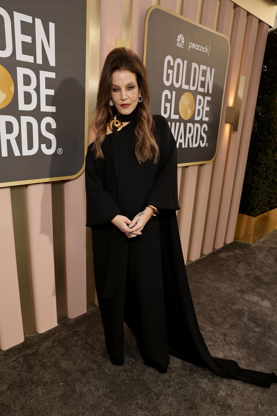 lisa marie presley posing for a photo at the golden globes red carpet