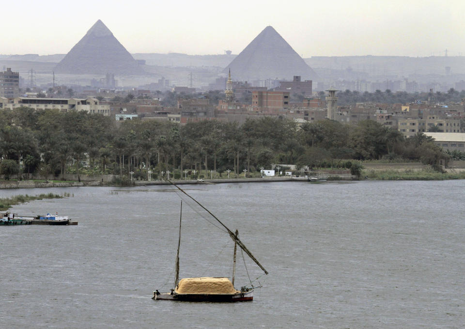 FILE - In this file photo of Tuesday, Jan. 22, 2013, a traditional felucca sailing boat carries a cargo of hay as it transits the Nile river passing the Pyramids of Giza in Cairo, Egypt, Irrigation ministers from three key Nile Basin countries wrapped up a two-day meeting Saturday in Sudan’s capital without agreeing on differences over Ethiopia’s soon-to-be-finished Blue Nile dam, with Egypt calling for international mediation to help reach a “fair and balanced” agreement. (AP Photo/Amr Nabil-File)