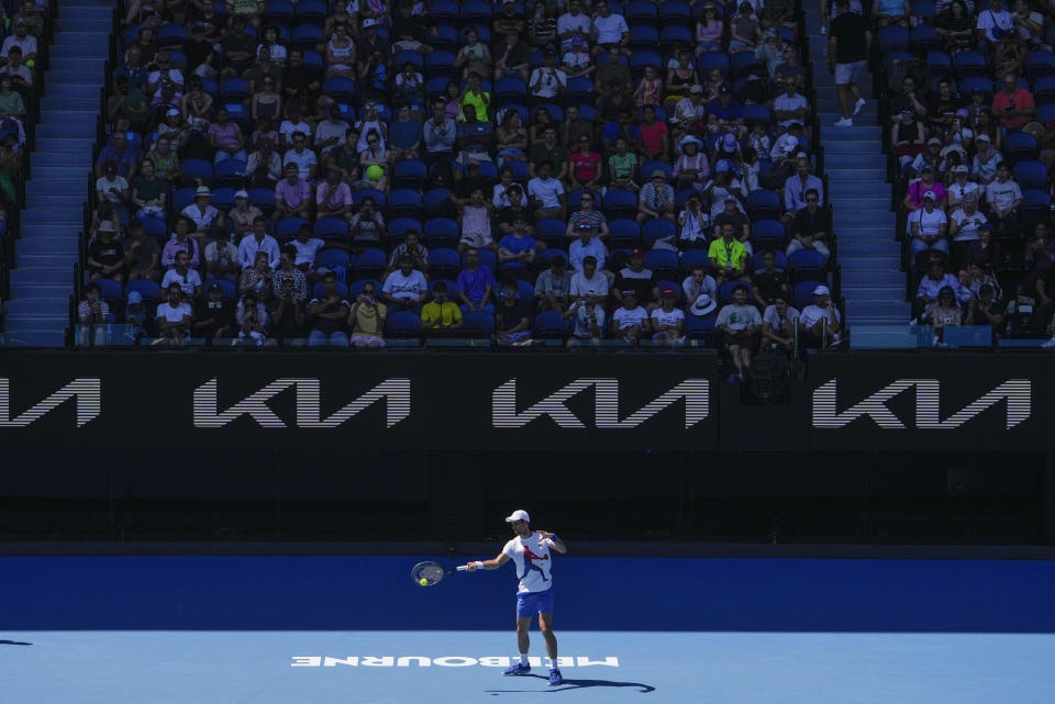 Spectators watch as Serbia's Novak Djokovic practices on Rod Laver Arena ahead of the Australian Open tennis championships at Melbourne Park, Melbourne, Australia, Friday, Jan. 12, 2024. (AP Photo/Andy Wong)