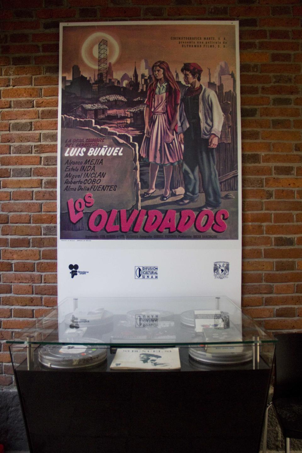 In this Aug. 1, 2013 photo, a poster of the movie "Los Olvidados" hangs on the wall at the "Casa Bunuel" in Mexico City. Despite that colorful legacy, Bunuel’s home is being presented as simply as the director left it, and not with the museum treatment given to the much-visited Mexico City abodes of Russian revolutionary Leon Trotsky and surrealist painter Frida Kahlo. (AP Photo/Gabriela Sanchez)